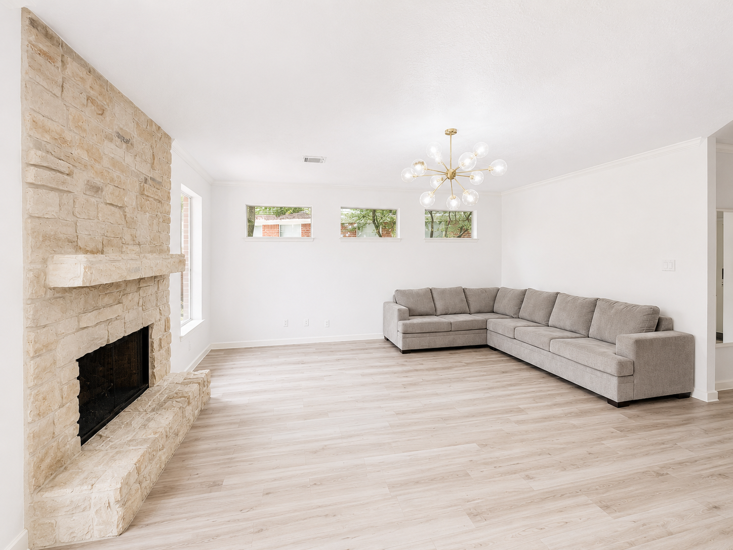An impressive living room centered around a dramatic stone fireplace, with tall windows and abundant room for gathering. An impressive living room centered around a dramatic stone fireplace, with tall windows and abundant room for gathering.